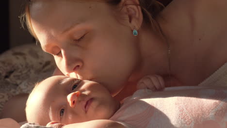 loving mother kissing baby