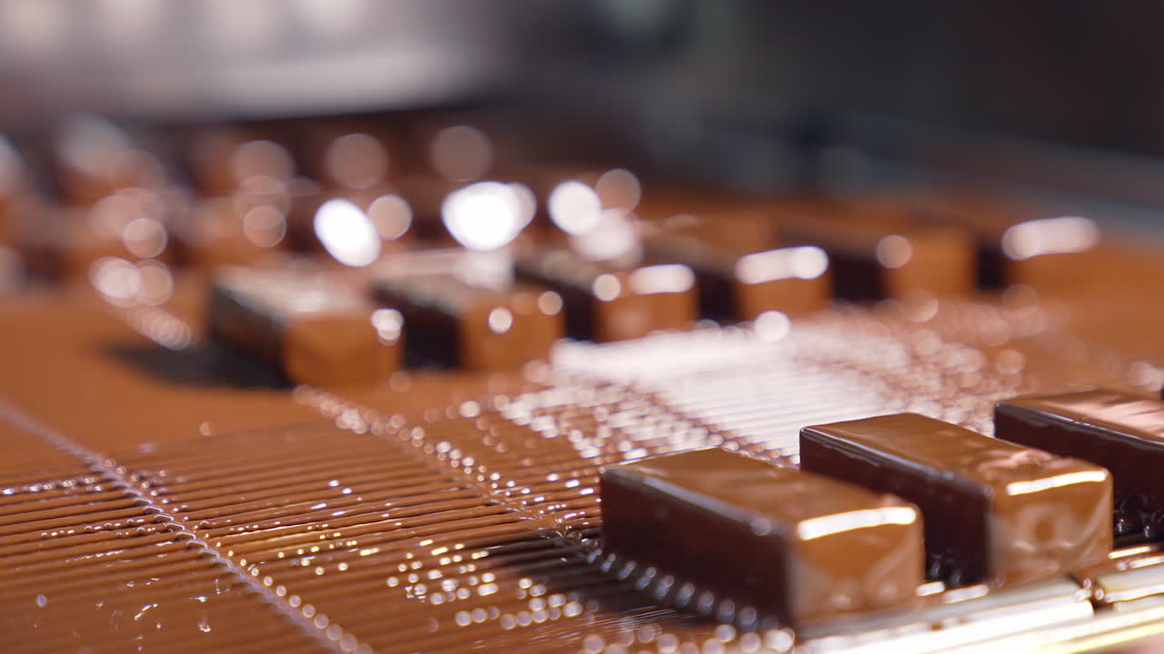 Tasty chocolate conveyor deserts. Sweet candies manufacturing on production line.