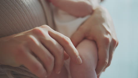 mother holding and caring for a baby