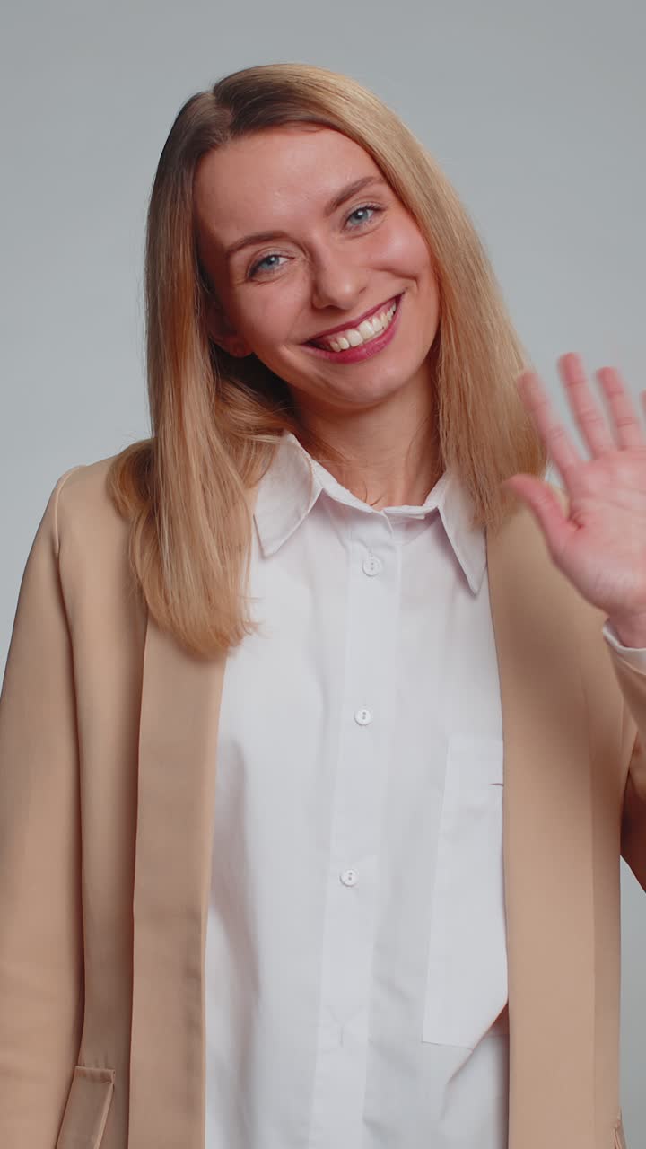 Woman showing inviting gesture with hands ask to join beckoning to coming gesturing hello goodbye