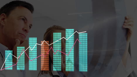 female doctor holding x-ray film in exam room, male doctor studying bar and line graph overlay