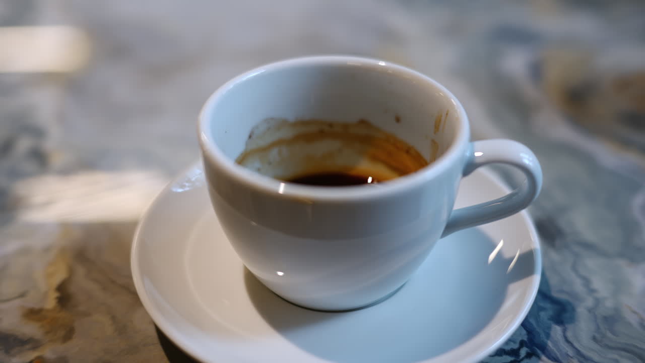 Close-up of a cup of espresso on a table at a cafe