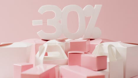 Minus-thirty-per-cent-text-in-white-with-pink-and-white-gift-boxes-on-pink-background