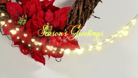 Animation-of-christmas-greetings-text-with-glowing-fairy-lights-and-christmas-decorations