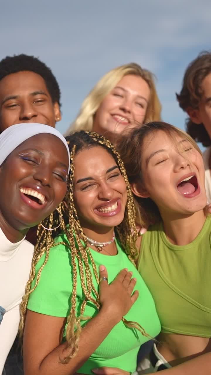 Multiracial group of people smiling taking a selfie outdoors