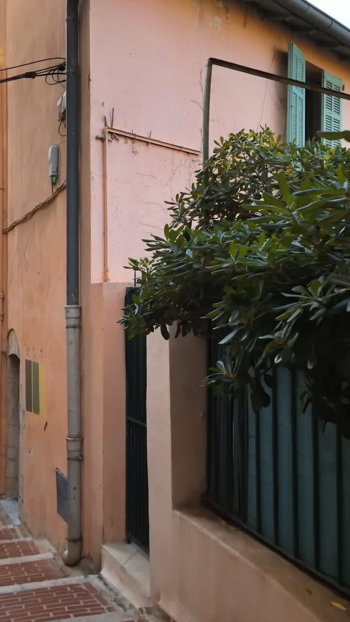 A walk on the street, down the stairs, between buildings in Cannes, France. Vertical