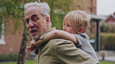 grandfather and grandson enjoying a piggyback ride