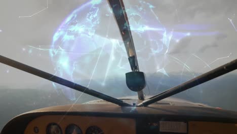 Globe-of-plexus-network-spinning-against-front-view-of-dashboard-of-private-aircraft