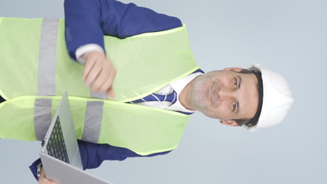 Vertical-video-of-Engineer-waving-at-camera.