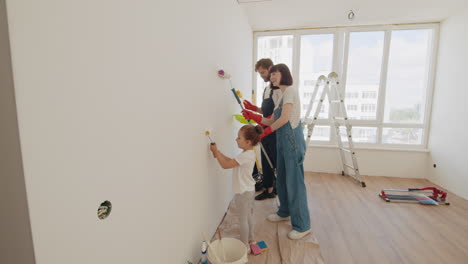 familia pintando una pared juntos