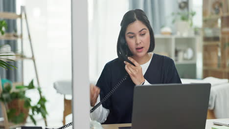 Telephone,-laptop-and-female-nurse-in-her-office