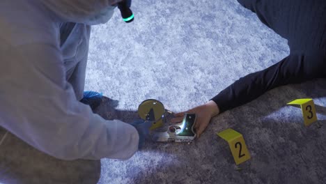 forensic expert examining the body of the man who committed suicide.