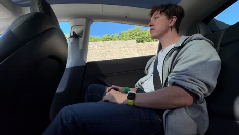 man inside a tesla car