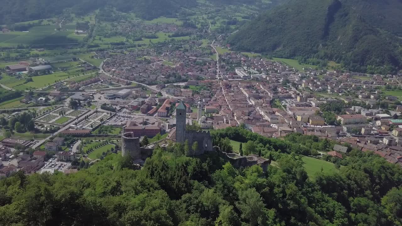 vista panorámica aérea de borgo valsugana en trentino italia con vistas a la ciudad y las montañas con drones volando detrás de castel telvana
