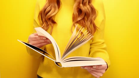 red hair woman reading book isolated on yellow background