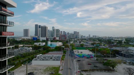 fly above street in urban neighbourhood. backwards reveal of modern luxurious apartment buildings. miami, usa