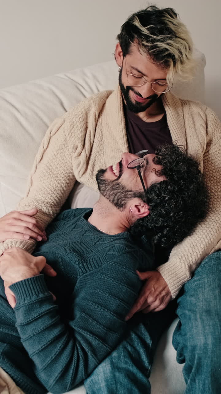 Gay Couple Relaxing Together At Home