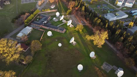 parabolic dish antennas pointing up in research facility, aerial orbit