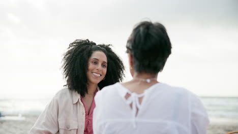 two women enjoying a conversation on the beach