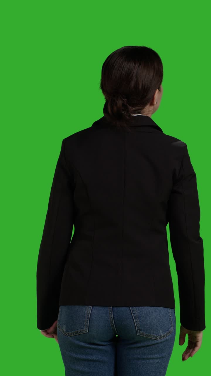 Vertical video: Back view close up of company employee raising hand and waving
