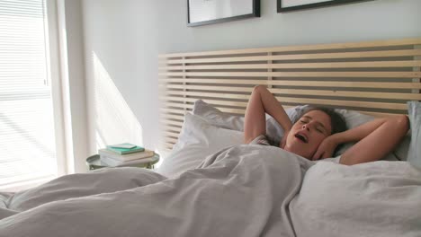 Young-woman-waking-up-in-her-bed/Chorzow/Poland