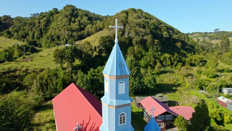 aerial panoramic landscape of chiloé patrimonial church, tenaun hills, skyline and blue architecture, religious landmark