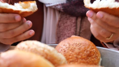 woman holding a bread bun