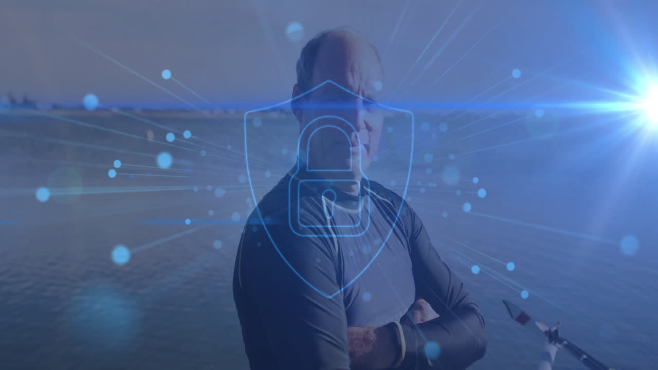 Senior man standing arms crossed on dock by water, showing digital security shield padlock overlay