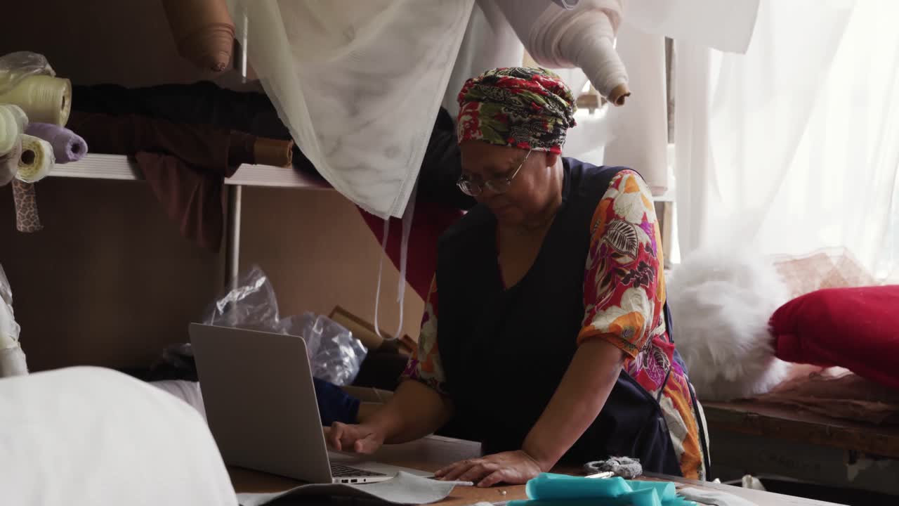 Mixed race woman working at a hat factory