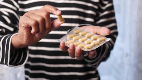 person holding a blister pack of pills