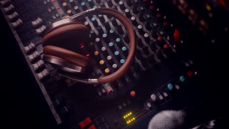 headphones on sound mixing control panel in music dj studio