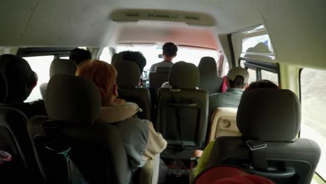 close-up of many people seated inside a mini-bus traveling