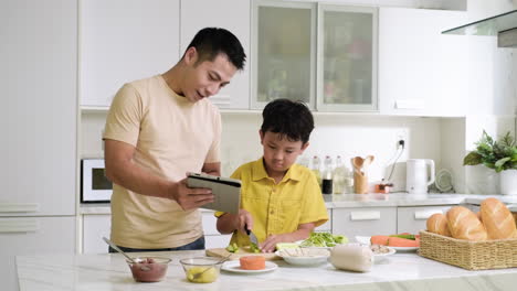 asian man and boy in the kitchen