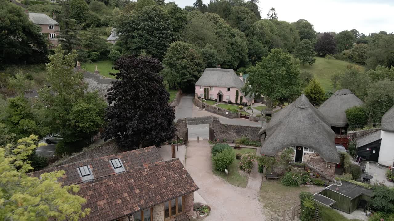 Cockington rural English countryside thatched cottage village aerial rising pull back scene