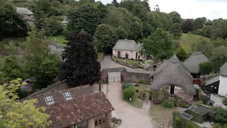 cockington rural english countryside thatched cottage village aerial rising pull back scene