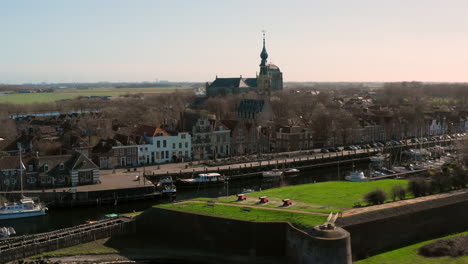 Aerial:-The-historical-town-of-Veere-with-an-old-harbour-and-churches,-on-a-spring-day