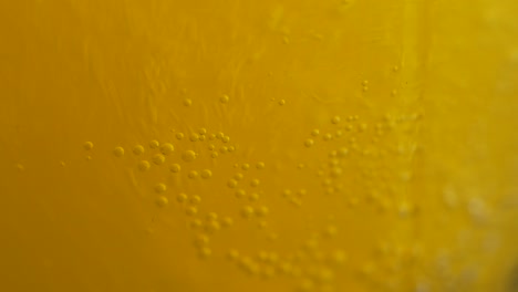 close-up of orange juice with bubbles