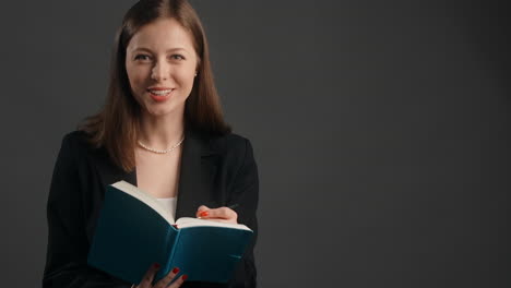 woman reading and taking notes