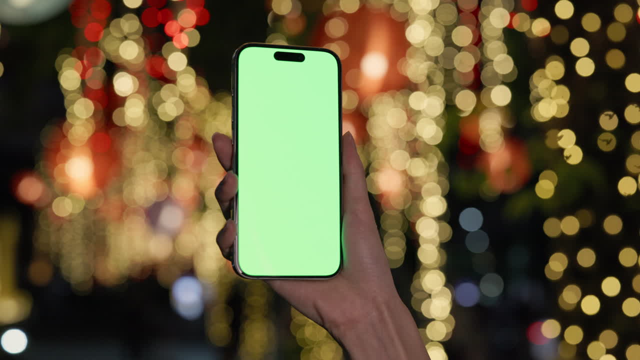 Smartphone con schermo verde e sfondo bokeh