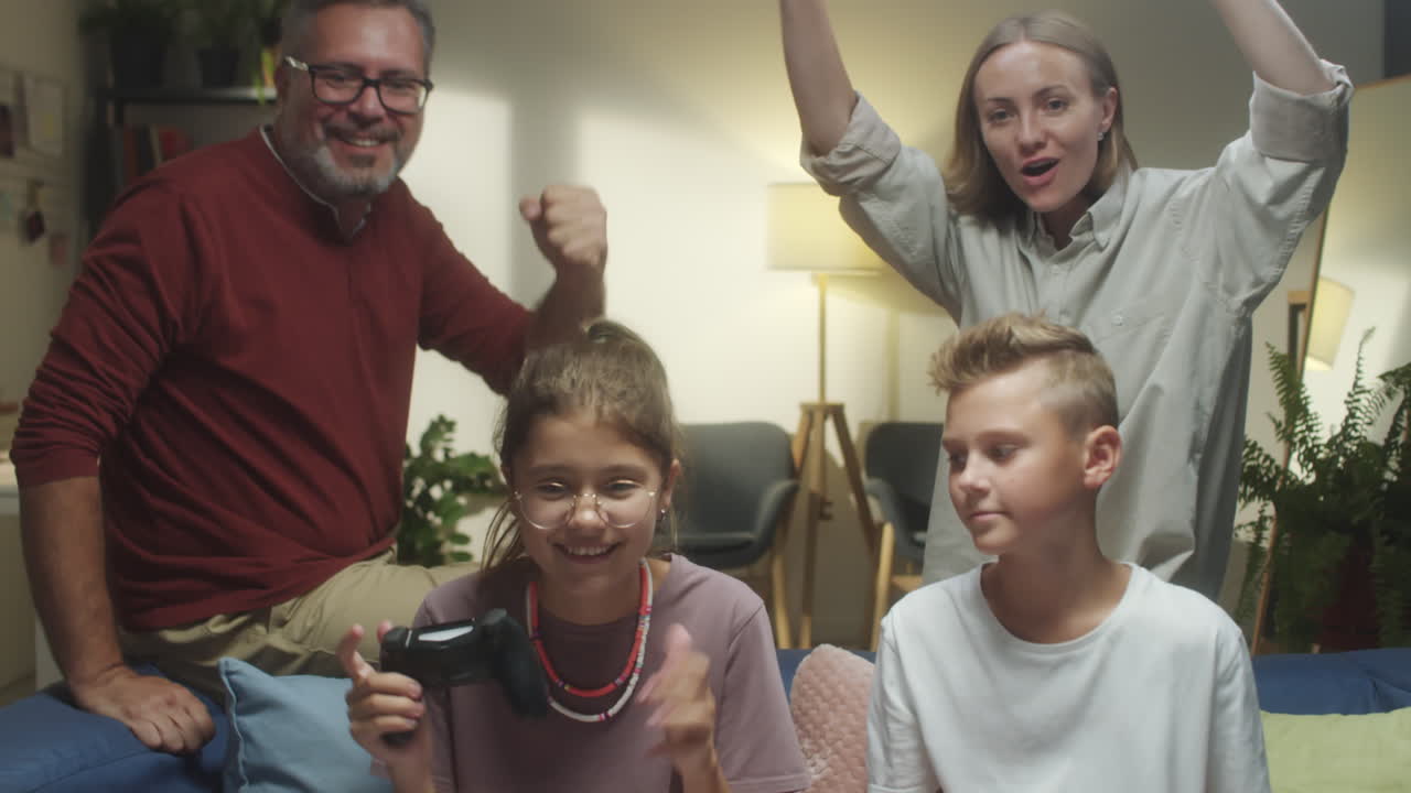 Family playing video games together in the living room