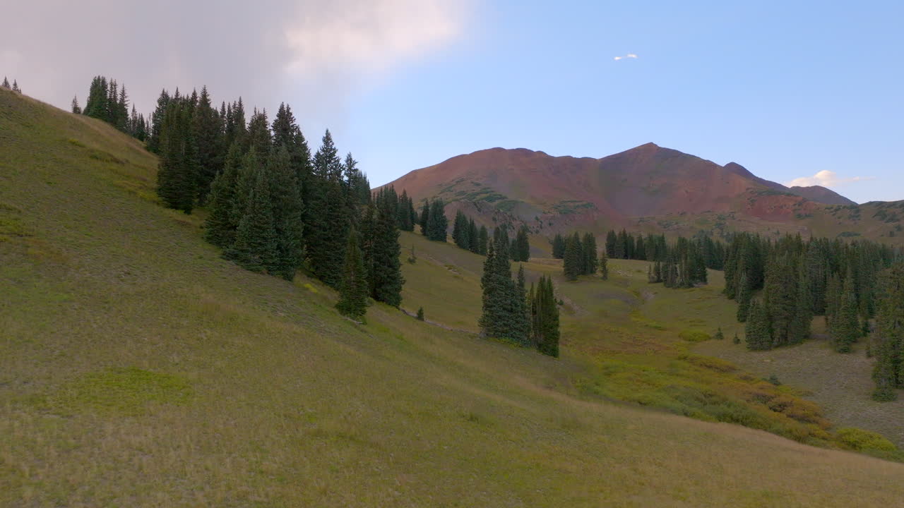 retírese de los árboles en una cresta y una montaña más allá en las montañas rocosas de colorado en un hermoso día
