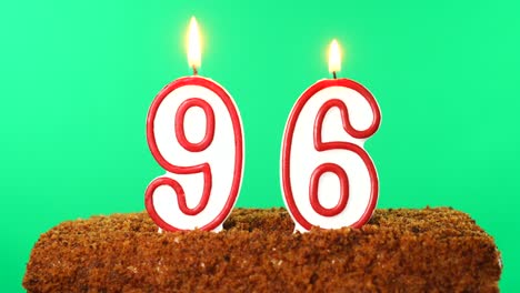 cake with the number 96 lighted candle. chroma key. green screen. isolated