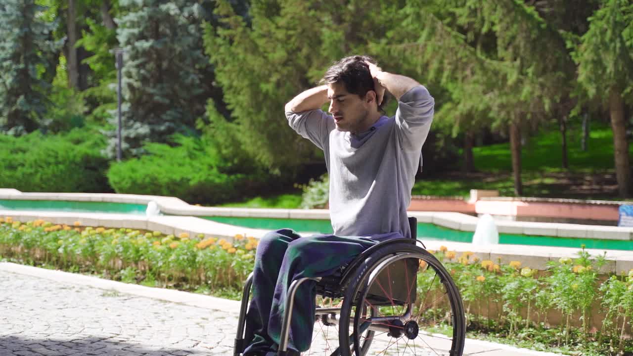 Disabled young man driving his wheelchair in slow motion.