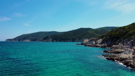 Turquoise-sea-and-a-beach-with-amazing-island-view-in-the-Mediterranean-with-crystal-clear-water-and-trees-in-the-background