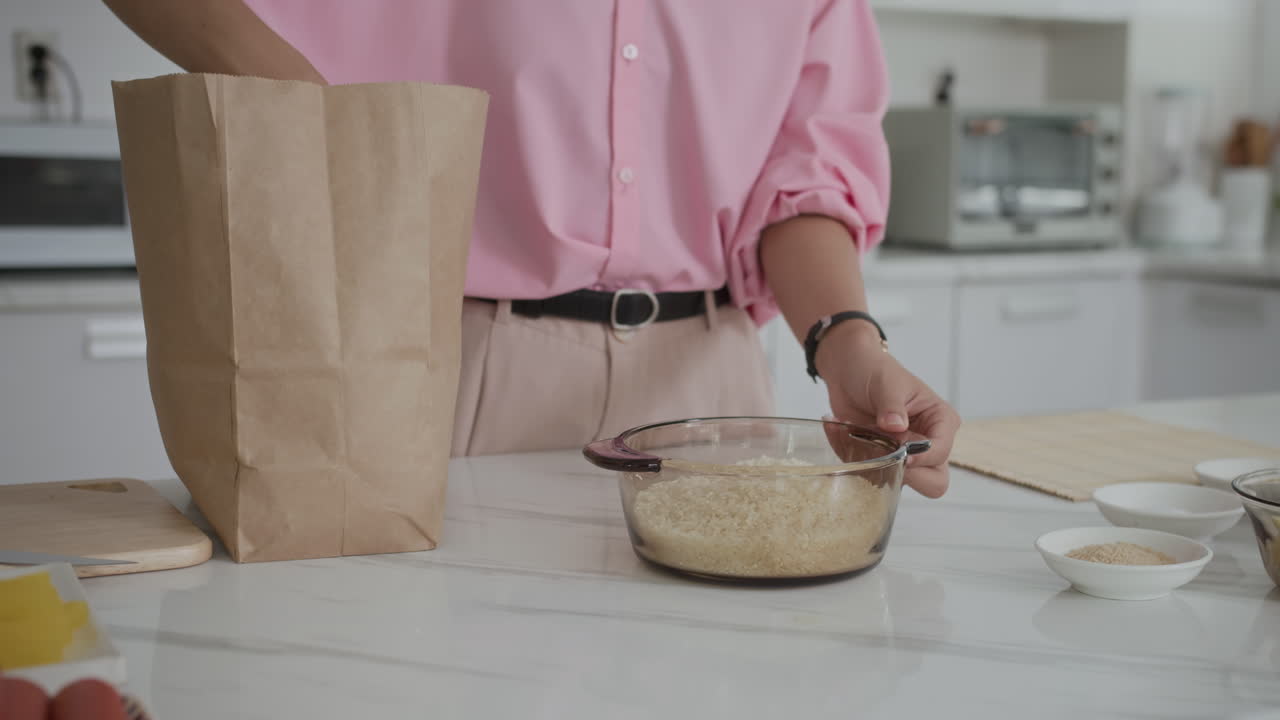 Anonymous Woman Adding Rice to Bowl at Home Kitchen
