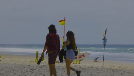 a couple strolls along the beach