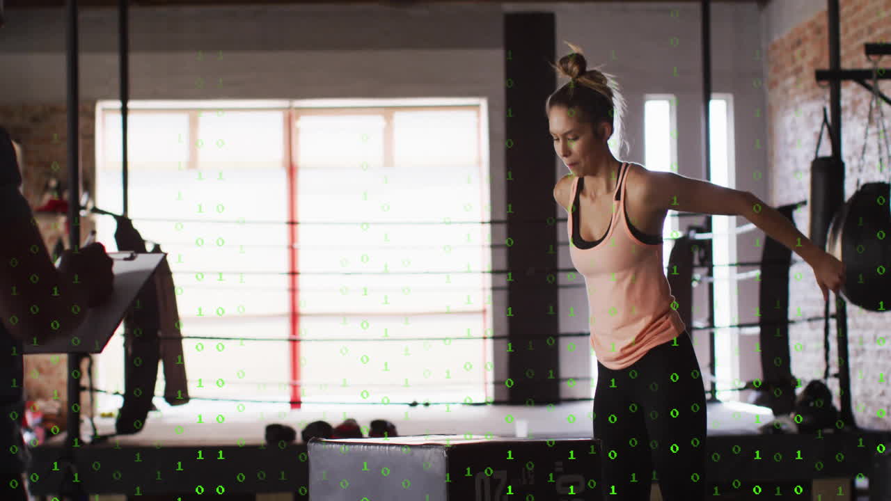 Woman exercising in gym with digital binary code animation overlay