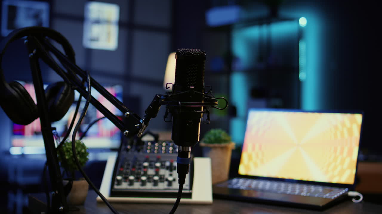 Zoom in on professional mic in dimly lit studio used for recording audio during internet show