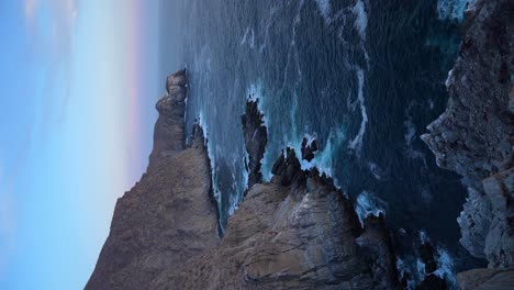 Vertical-shot-of-Punta-Lobos,-waves-crashing-against-rocky-sea-cliffs,-near-Todos-Santos,-BCS,-Mexico