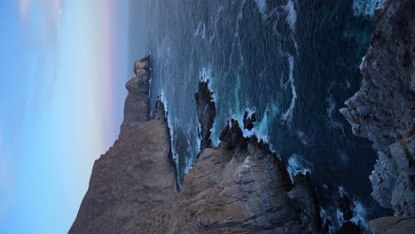 Vertical shot of Punta Lobos, waves crashing against rocky sea cliffs, near Todos Santos, BCS, Mexico